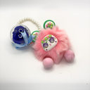 Plush charm preserved rose keychain featuring a real forever rose displayed inside a round clear plastic box by ZESO Blooms™