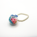 Real preserved rose round keychain displayed in a clear round plastic container with decorative pearl chain by ZESO Blooms™