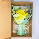 Bouquet of yellow and white flowers in a cardboard box