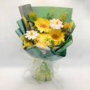 Bouquet of yellow and white flowers wrapped in green paper on a white background