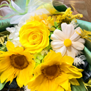Bouquet of yellow sunflowers and white roses with greenery.
