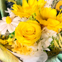 Bouquet of yellow and white flowers with greenery